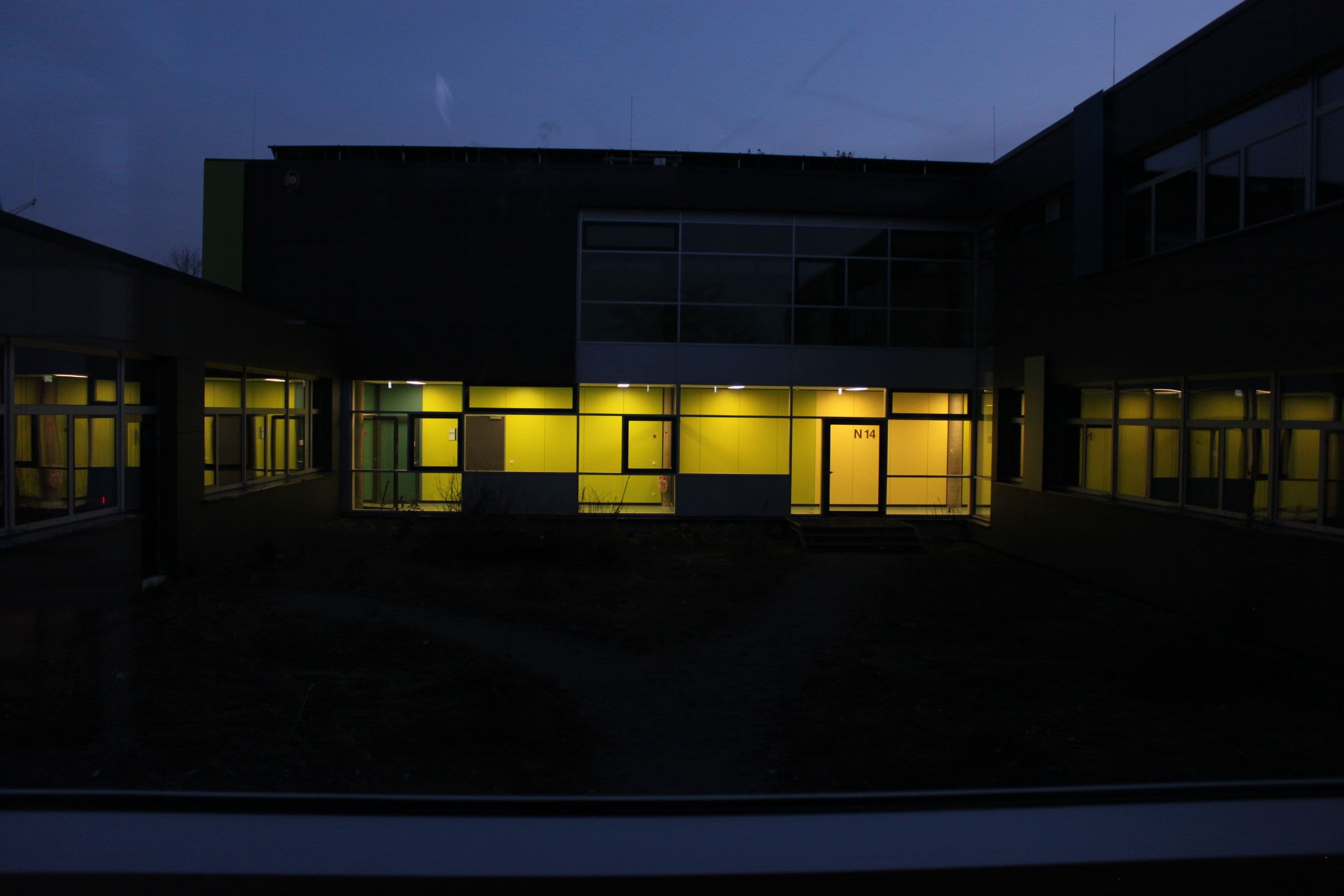 a building with a lot of windows is lit up at night .