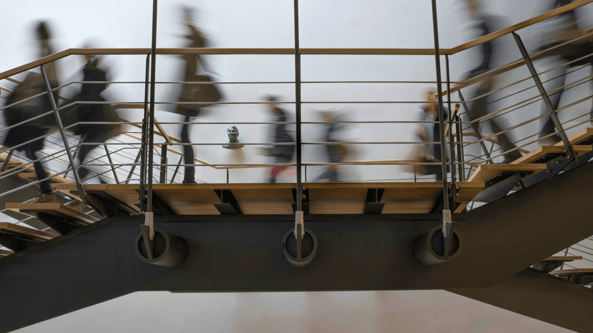 a blurry picture of people walking down stairs